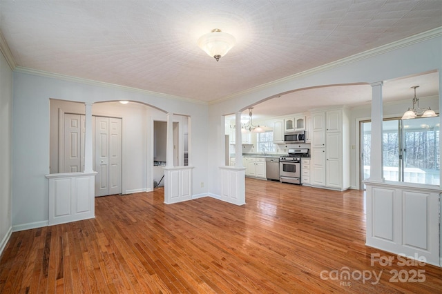 8080 Monbo Rd, Catawba, NC 28609 - interior space with arched walkways, a chandelier, light wood-style flooring, baseboards, and ornate columns