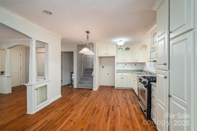 8080 Monbo Rd, Catawba, NC 28609 - kitchen with wood finished floors, a sink, appliances with stainless steel finishes, decorative columns, and pendant lighting