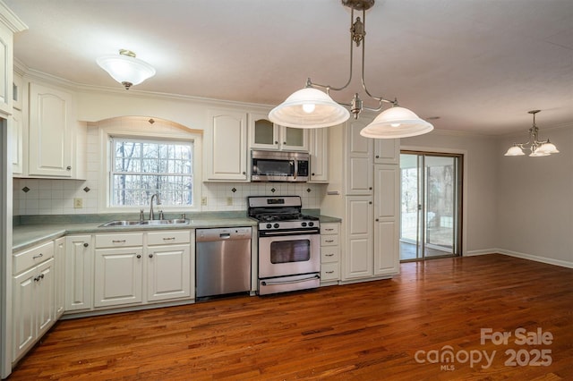 8080 Monbo Rd, Catawba, NC 28609 - kitchen with appliances with stainless steel finishes, ornamental molding, dark wood-style flooring, hanging light fixtures, and a sink