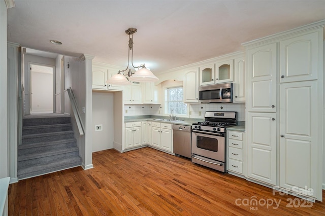 8080 Monbo Rd, Catawba, NC 28609 - kitchen featuring tasteful backsplash, wood finished floors, stainless steel appliances, light countertops, and a sink