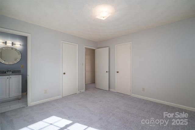 8080 Monbo Rd, Catawba, NC 28609 - unfurnished bedroom featuring light carpet, ensuite bathroom, a sink, and multiple closets