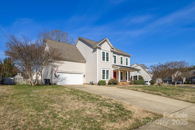 traditional-style home with an attached garage, a shingled roof, fence, a front yard, and driveway