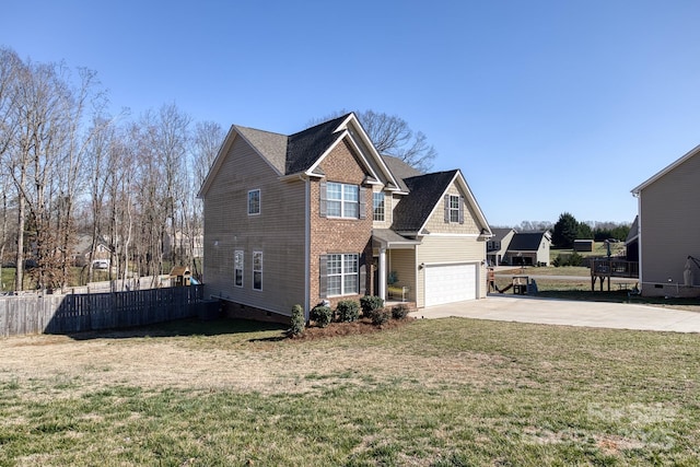 view of side of property with concrete driveway, an attached garage, fence, a yard, and brick siding