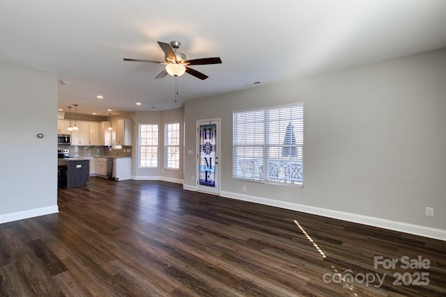 unfurnished living room with visible vents, baseboards, a ceiling fan, dark wood-style floors, and recessed lighting