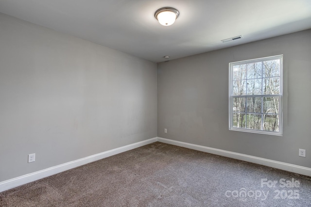 carpeted empty room with baseboards and visible vents