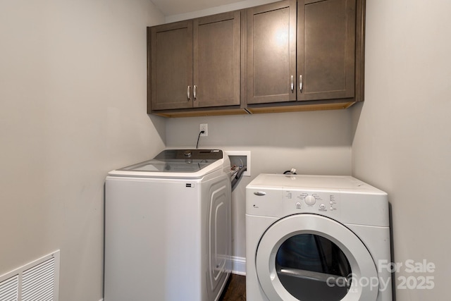 laundry room with cabinet space, visible vents, and independent washer and dryer