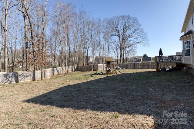 view of yard featuring a fenced backyard and a playground