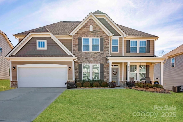 craftsman inspired home with driveway, stone siding, a porch, and a front lawn