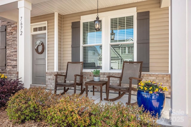 entrance to property with stone siding and covered porch