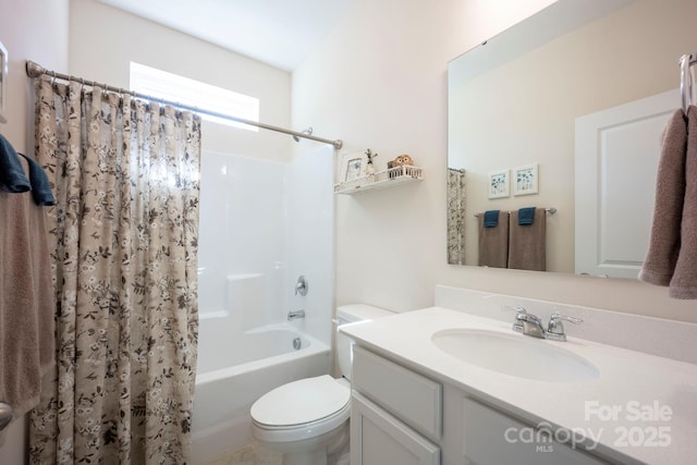 full bathroom with shower / tub combo with curtain, vanity, and toilet