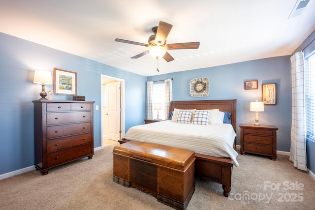 bedroom featuring light colored carpet, ceiling fan, visible vents, and baseboards