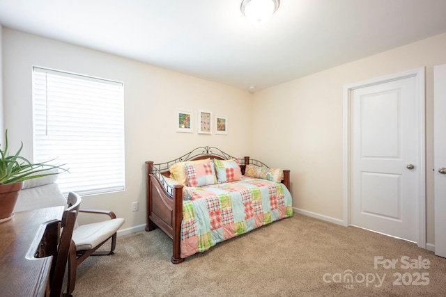 carpeted bedroom featuring baseboards