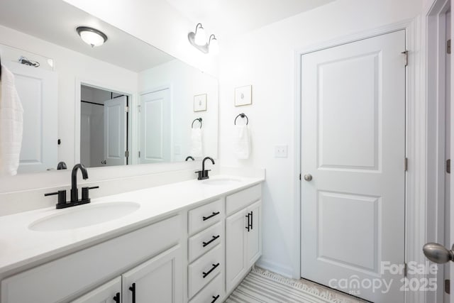 full bath featuring a sink and double vanity