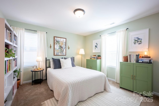 bedroom with light carpet, visible vents, and baseboards