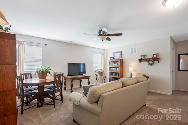 living room featuring carpet, visible vents, ceiling fan, and baseboards