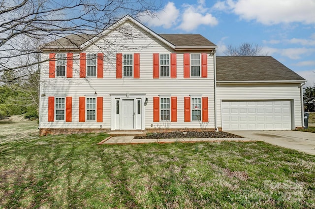 colonial house featuring an attached garage, concrete driveway, and a front yard