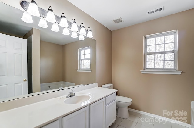 full bathroom featuring toilet, tile patterned flooring, visible vents, and a bath