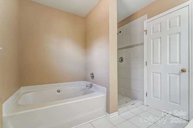 bathroom with a stall shower, tile patterned flooring, and a garden tub