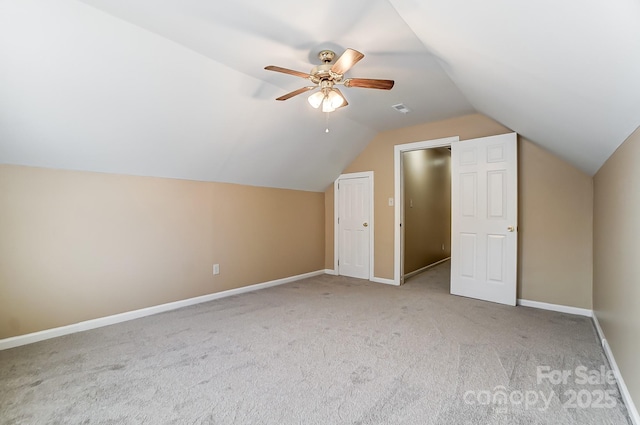 additional living space featuring lofted ceiling, ceiling fan, carpet flooring, visible vents, and baseboards