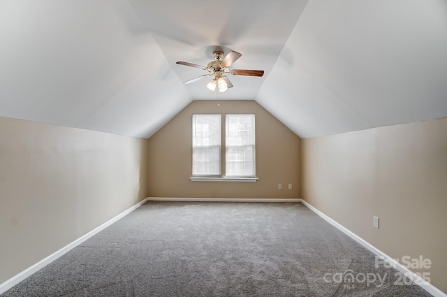 additional living space featuring lofted ceiling, carpet, a ceiling fan, and baseboards