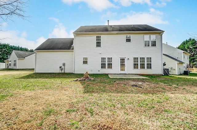 back of house with a patio and a lawn