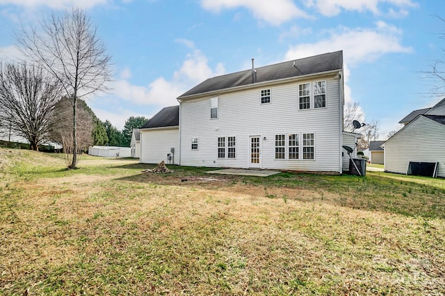 rear view of property featuring a yard and a patio