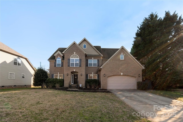 traditional home featuring a garage, a front yard, brick siding, and driveway