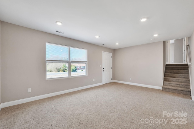 empty room featuring recessed lighting, carpet floors, visible vents, baseboards, and stairs