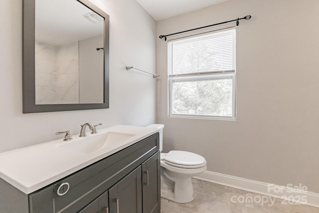 bathroom with toilet, baseboards, walk in shower, and vanity