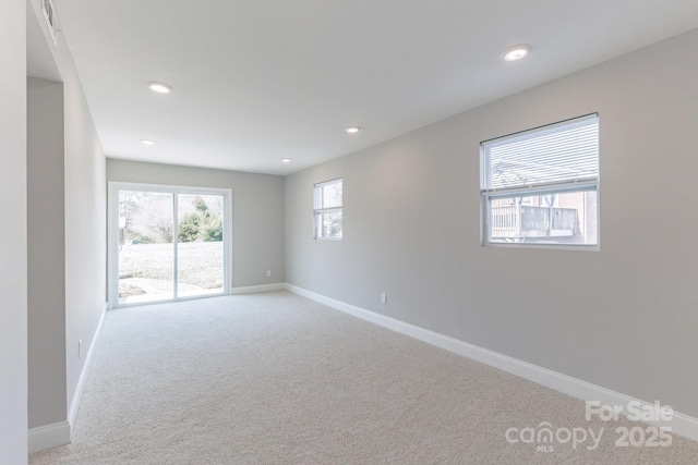 carpeted empty room featuring recessed lighting and baseboards