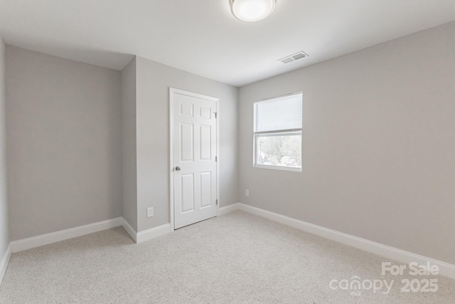 unfurnished bedroom featuring light carpet, baseboards, and visible vents