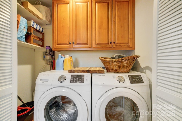 laundry area with washing machine and dryer and cabinet space