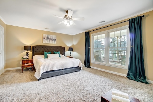 carpeted bedroom featuring ornamental molding, visible vents, and baseboards