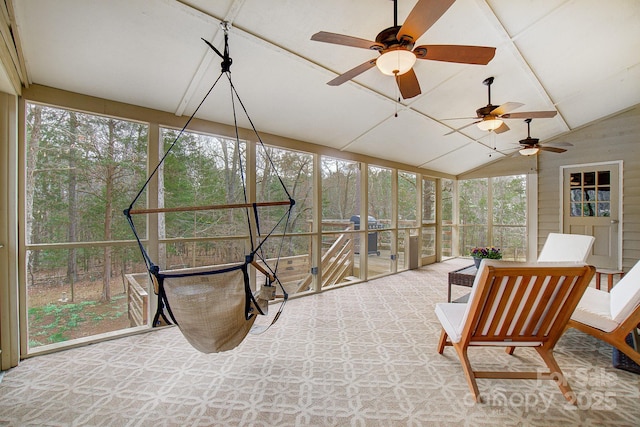 sunroom / solarium featuring a healthy amount of sunlight and vaulted ceiling