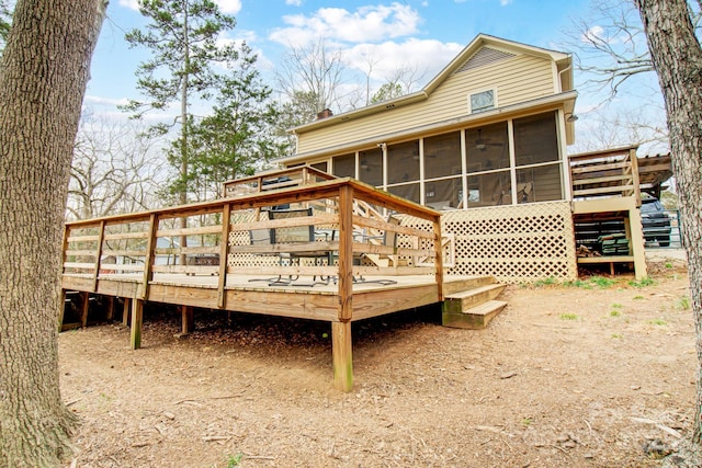 rear view of property with a sunroom, stairway, and a wooden deck