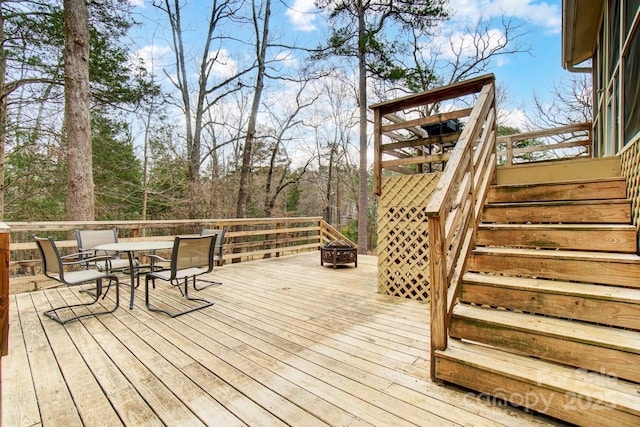 deck with an outdoor fire pit, outdoor dining area, and stairs