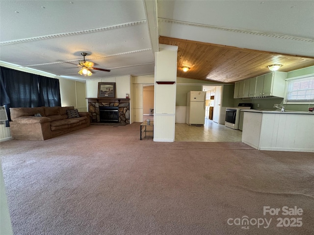 unfurnished living room with light carpet, a ceiling fan, wood ceiling, vaulted ceiling, and a fireplace