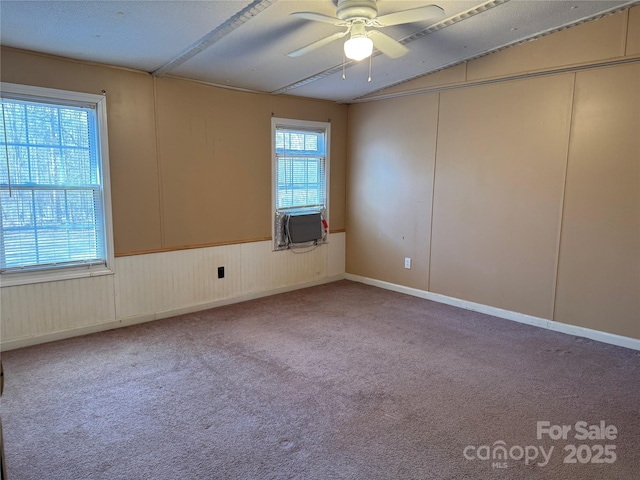 unfurnished room featuring ceiling fan, cooling unit, vaulted ceiling, and carpet flooring