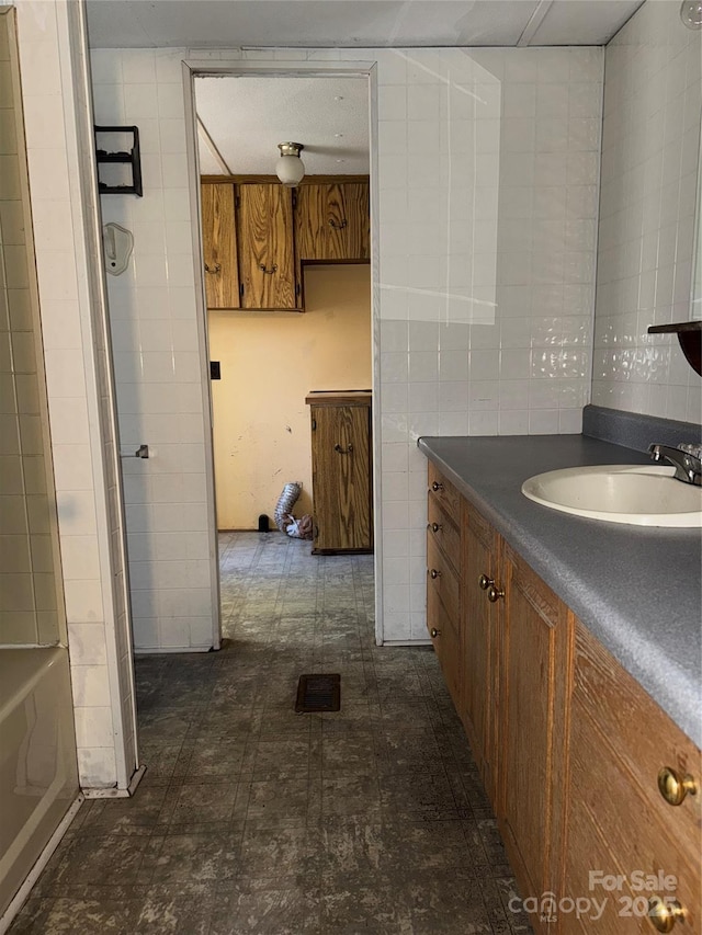 bathroom with tile walls and vanity