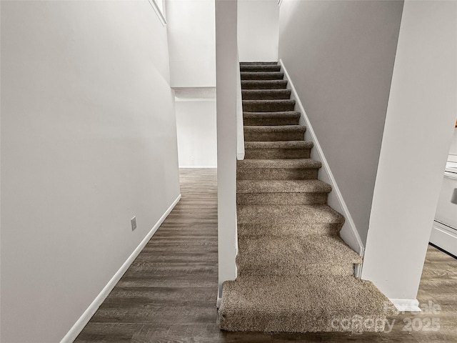 stairs with baseboards and wood finished floors