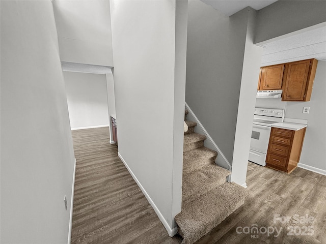 stairs featuring baseboards and wood finished floors