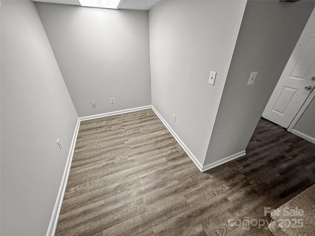 interior space with baseboards and wood finished floors