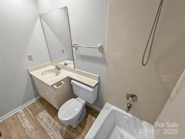 bathroom featuring bathtub / shower combination, toilet, wood finished floors, vanity, and baseboards