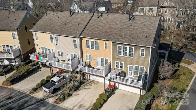 back of property featuring roof with shingles