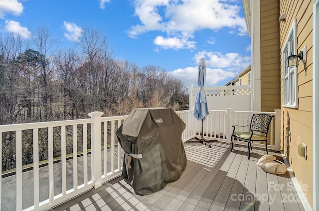 wooden terrace featuring a grill