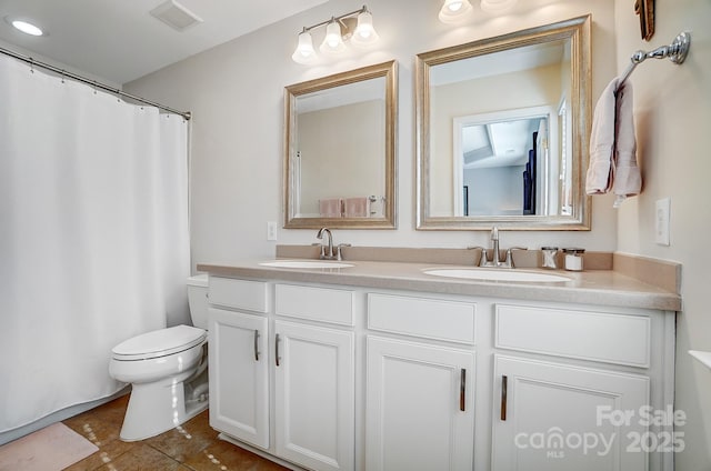 full bathroom with visible vents, a sink, toilet, and double vanity