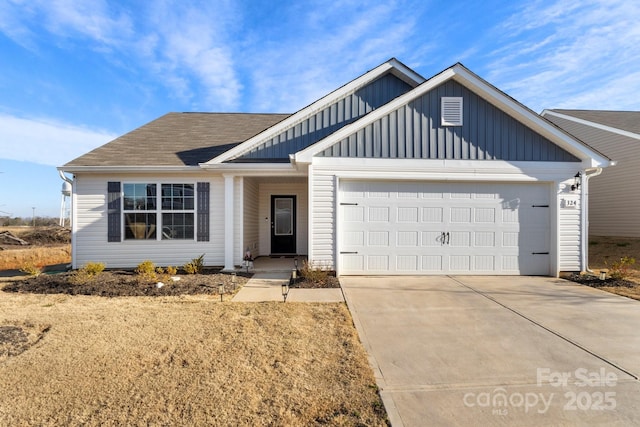 view of front of house with a garage, board and batten siding, concrete driveway, and roof with shingles