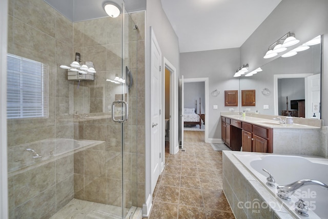 ensuite bathroom featuring a garden tub, double vanity, ensuite bathroom, a shower stall, and tile patterned floors