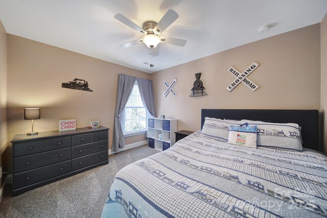 carpeted bedroom featuring ceiling fan and baseboards