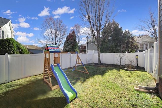 view of yard with a playground and a fenced backyard